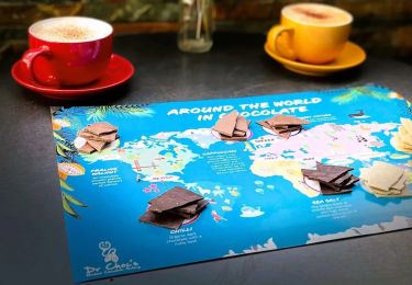 World map with chocolate squares placed on top. 