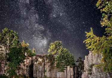 View staring up at stars beyond cliff tops